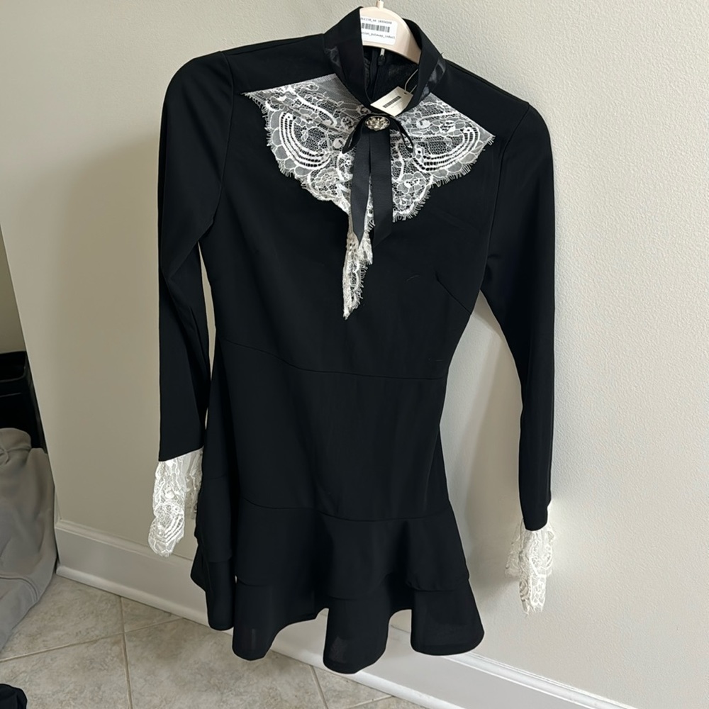 Black mini dress with white lace collar and wrists
